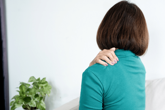 A woman suffers from shoulder pain